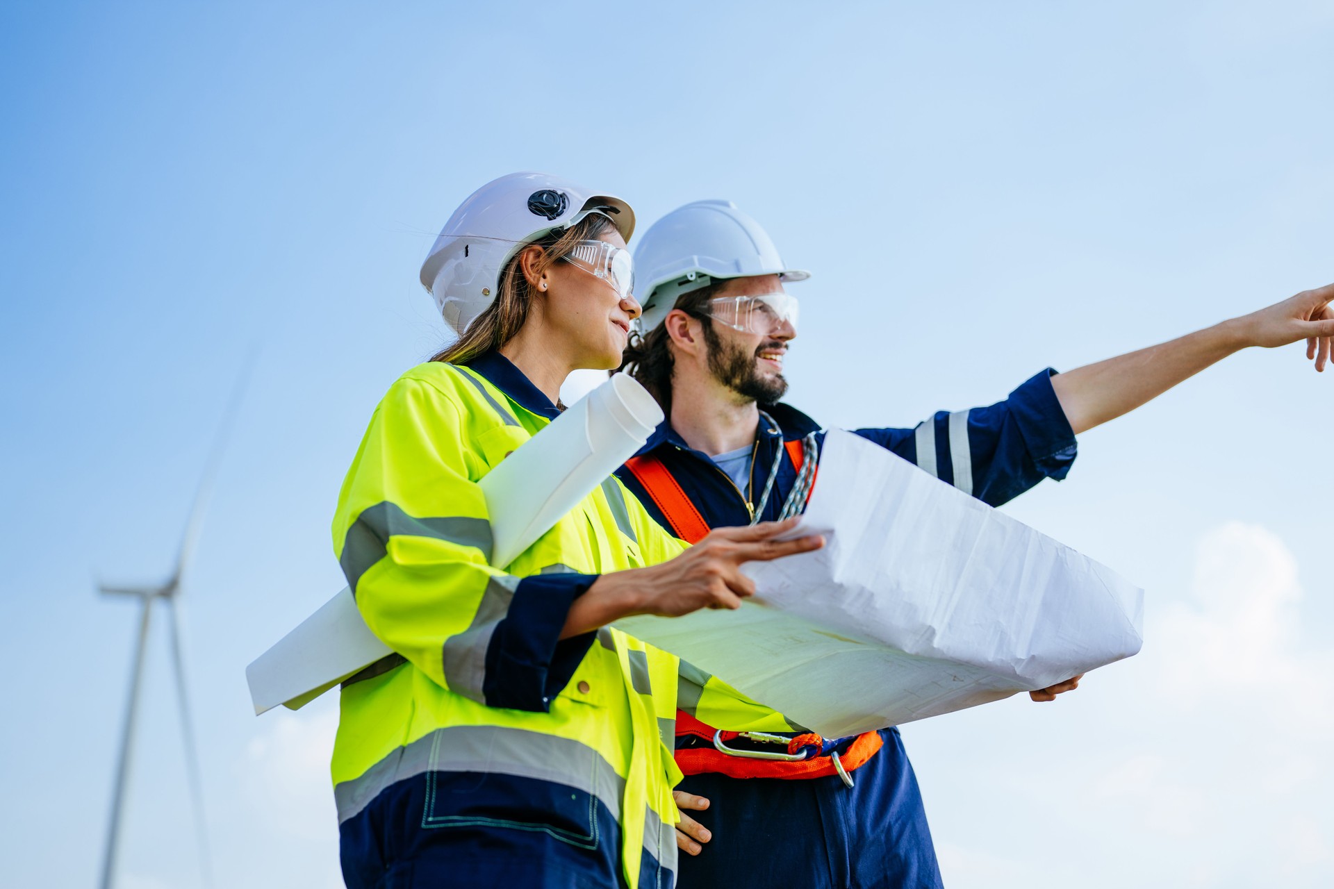 Professional engineers technicians working at wind turbine farm field